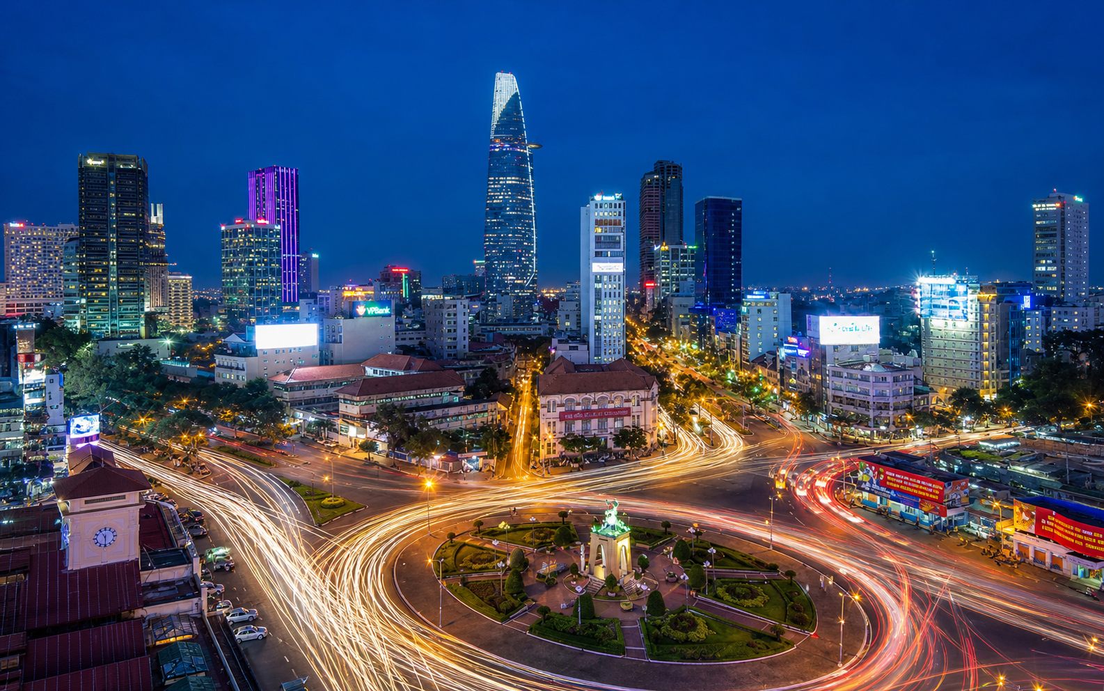 Ho Chi Minh City District 1 night skyline with traffic light trails